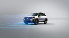 3/4 front view of grey Passport. Blue sensor waves and lines emit from the front.