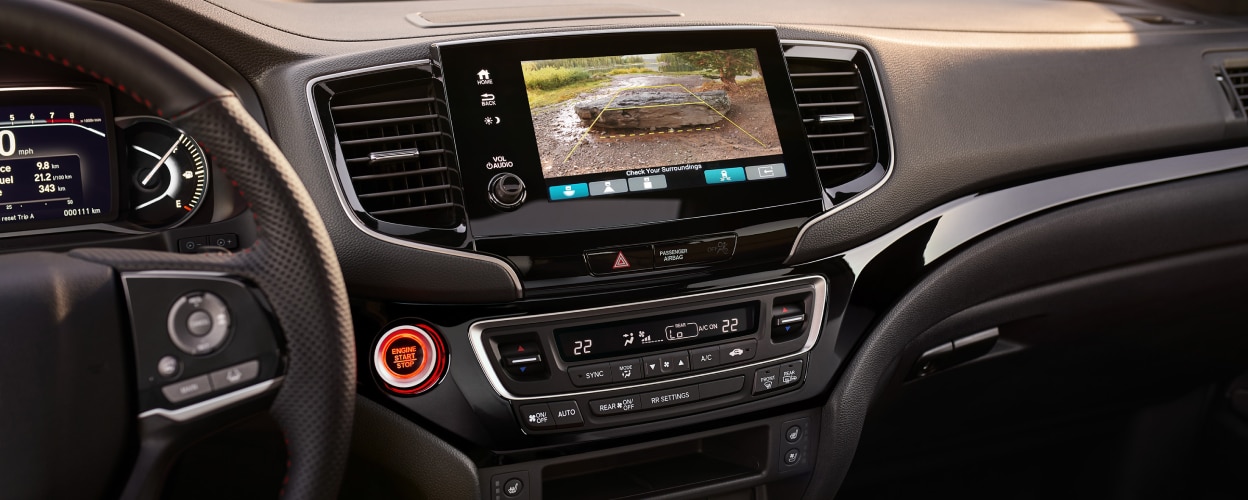 Closeup of centre console touchscreen projecting what the rear camera sees.