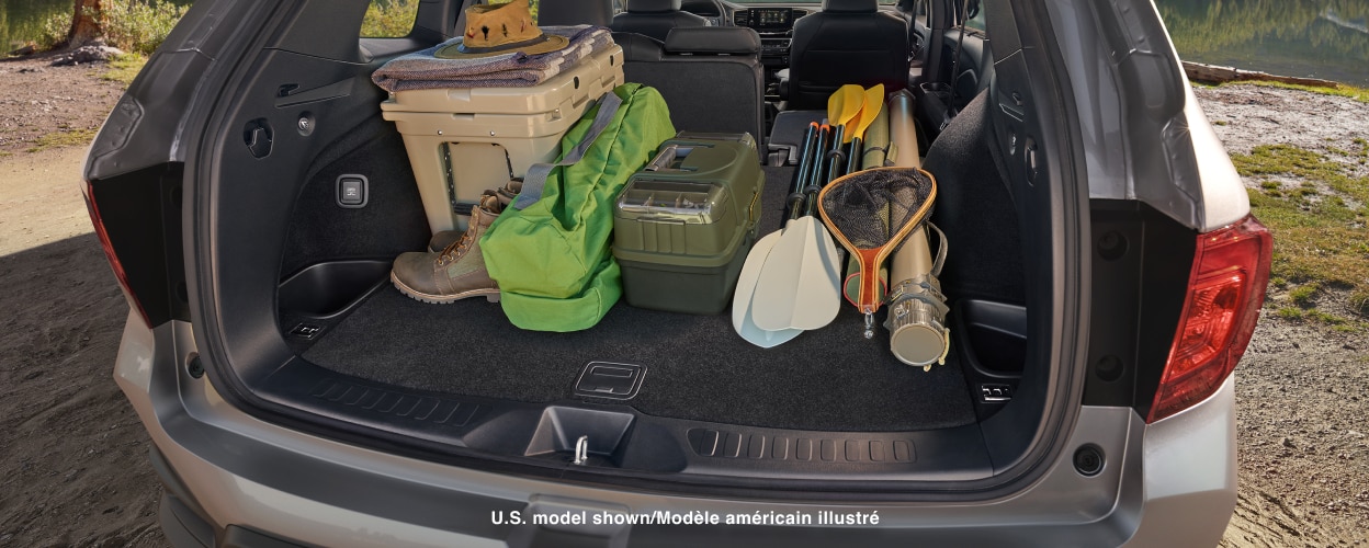 Open trunk, loaded with camping/fishing gear.