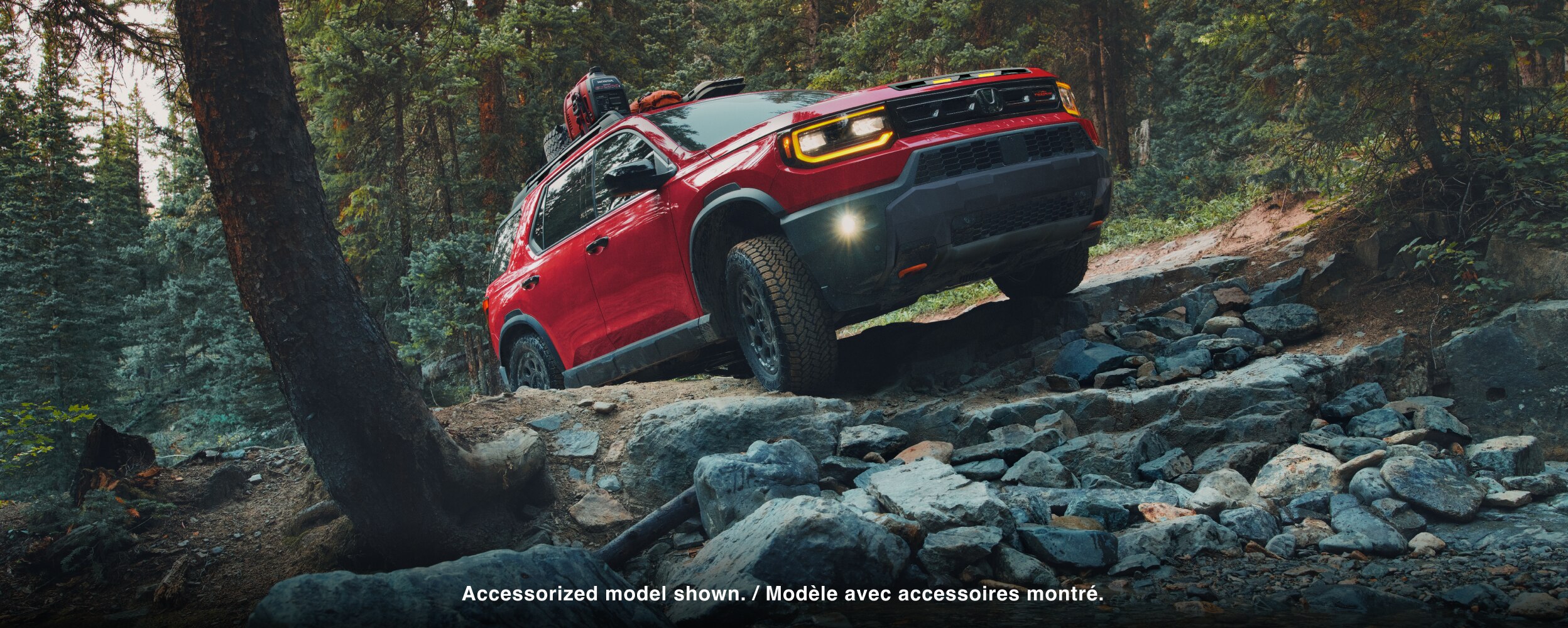 A red Passport driving on rough mountain terrain. 