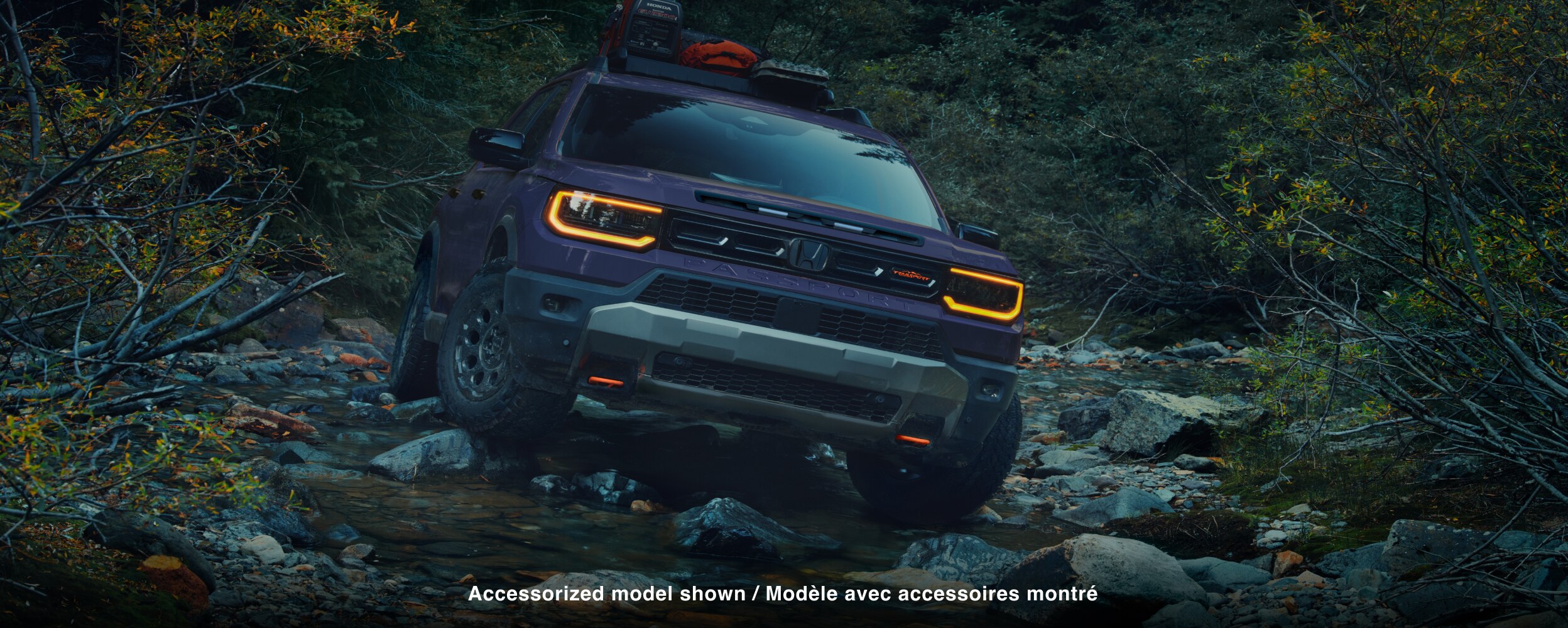 Closeup of front grill with headlights on. 