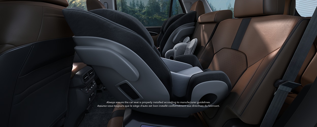 Side view of baby seat in the second row with brown and black seats.
