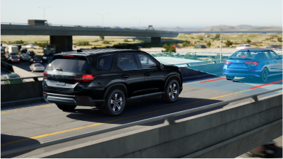 3/4 rear view of black Pilot on highway over pass. Blue sensor lines and waves detect a traffic sign.