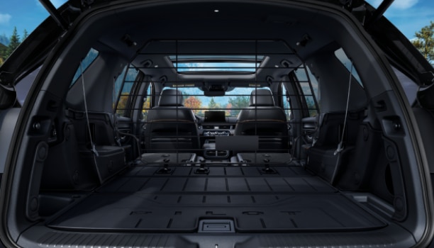 Straight-on view of tailgate open showcasing the vast cargo space with 2nd and 3rd-row seats flat-folded down.
