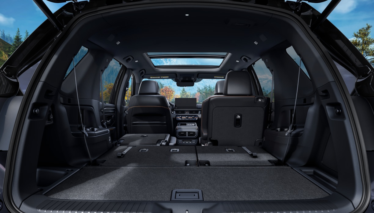 Rear view of the Pilot’s trunk interior with the back row of seats folded down.