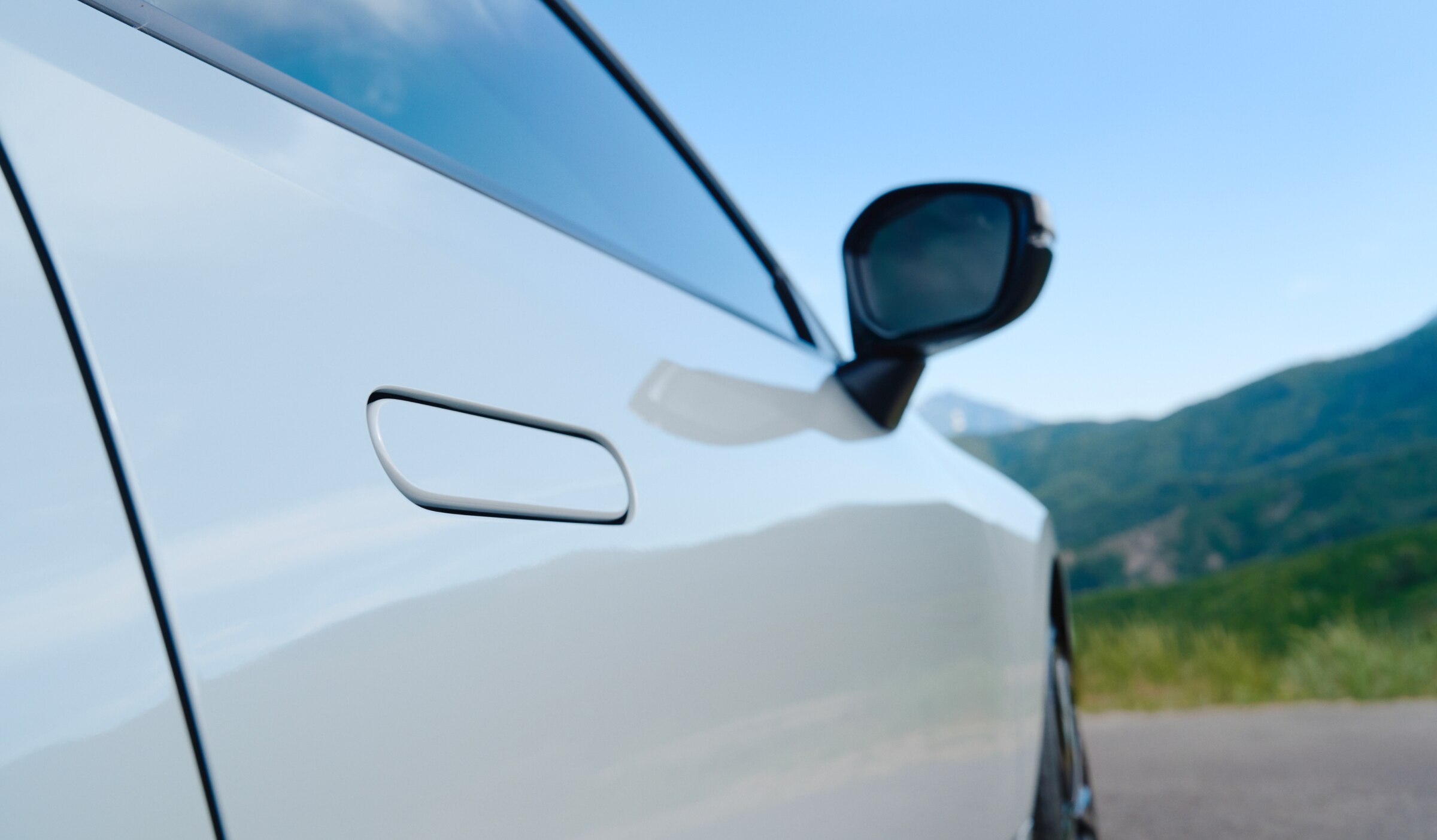 Closeup of a white Prelude's front passenger side door and mirror. 