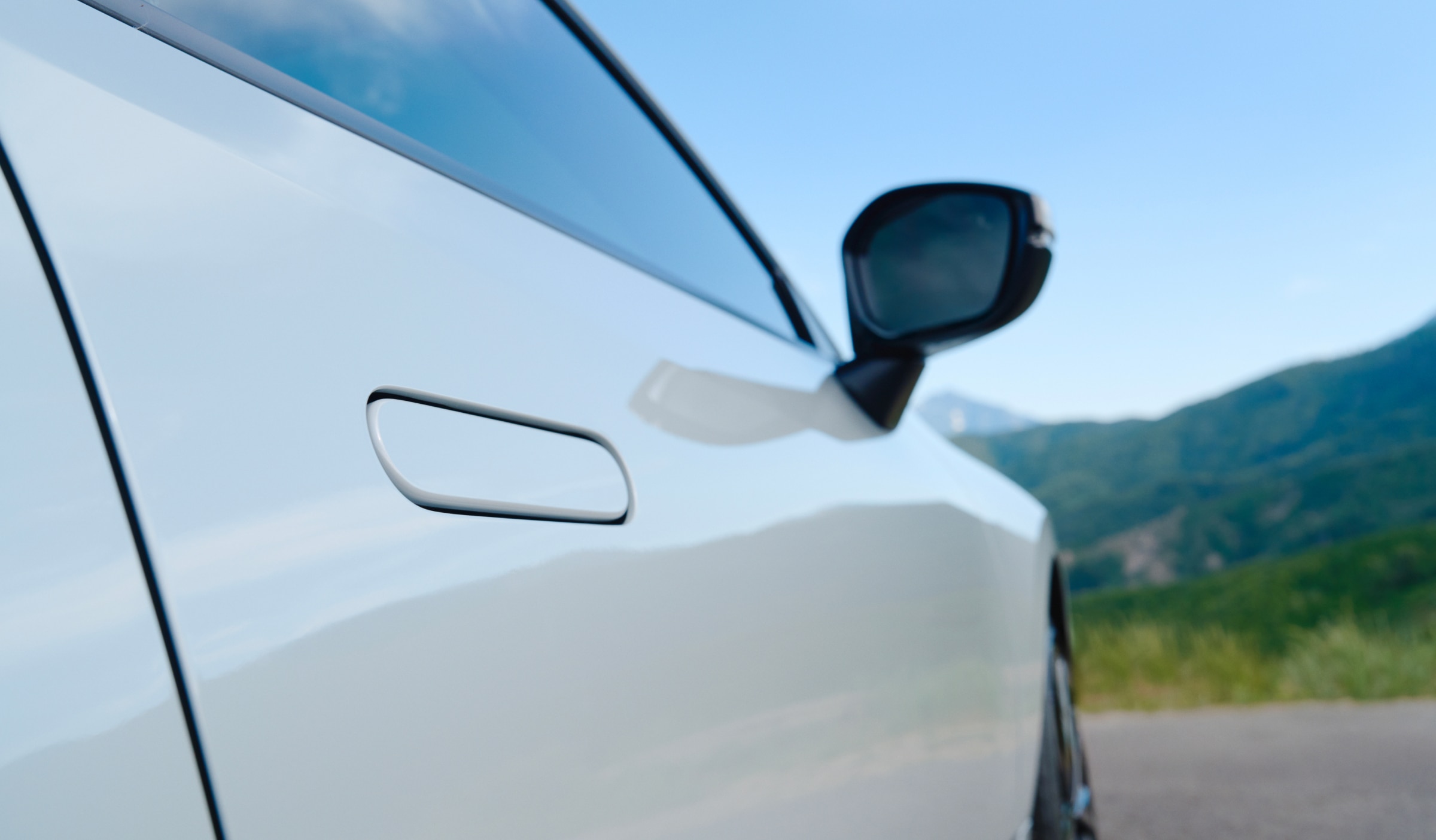 Closeup of a white Prelude's front passenger side door and mirror.