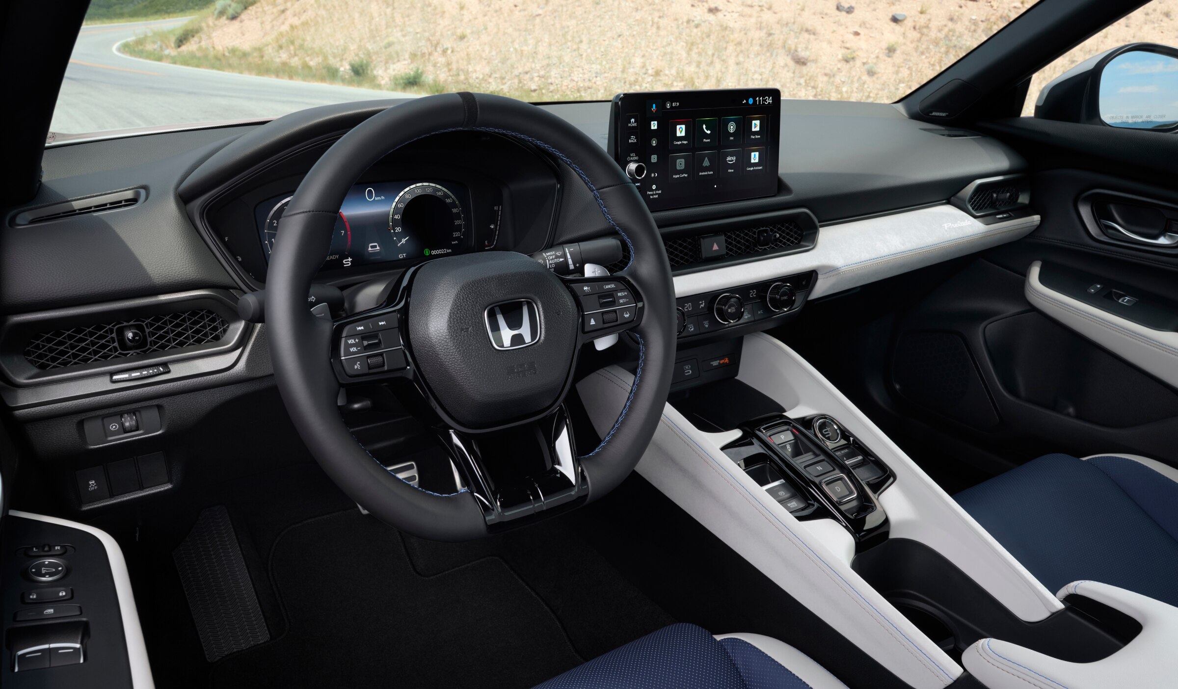 Driver's side view of the steering wheel and dashboard.