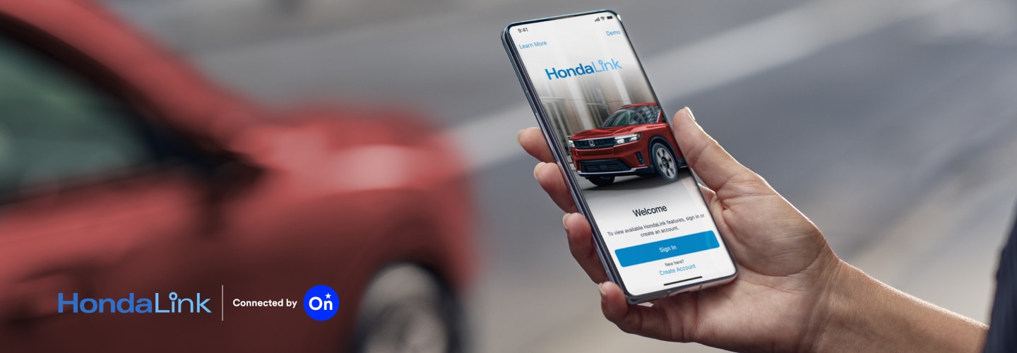 Closeup of a smartphone on white space with the HondaLink™ app interface displayed.