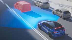 Computer-generated illustration with a 3/4 bird’s eye rear view of a blue Prologue on a city street. Blue sensor waves emit from the front, detecting a car in front of the Prologue.