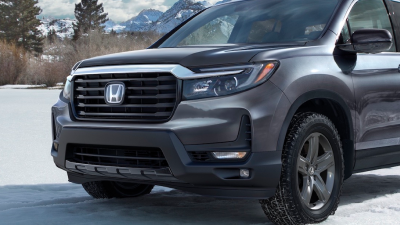 3/4 front view of grey Honda Ridgeline in the snowy outdoors.