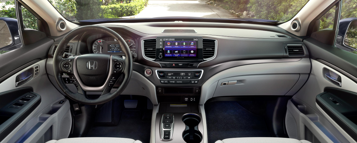 Panoramic interior view of the front steering wheel/dashboard/front console of Ridgeline.