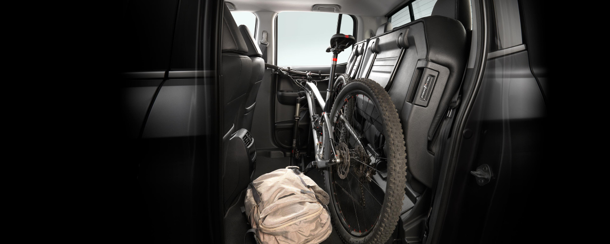 Side view of back row of Ridgeline storing a bike and a backpack.