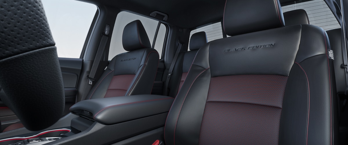 Closeup of Ridgeline driver’s seat with red contrast stitching and “Black Edition” debossed on the seatback.