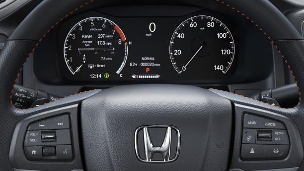 Closeup of steering wheel and TFT Center Meter Display, showcasing speedometer, tachometer, odometer, and other info.
