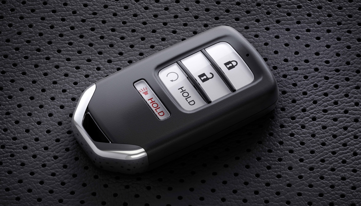 Closeup of key fob sitting on perforated seat.