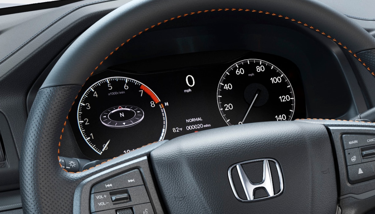 Closeup of steering wheel and TFT Center Meter Display, showcasing speedometer, tachometer, odometer, and other info.