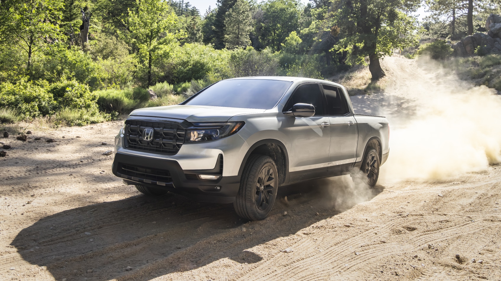 Front view of grey Ridgeline on desert hills.