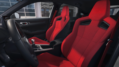 Interior wide shot of the two front red bucket sports seats. 