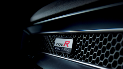 Closeup of Type R serial number plate on the honeycomb vent on the front passenger dashboard. 