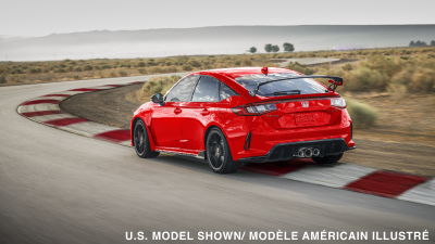 3/4 rear view of red Type R taking a turn on track. 
