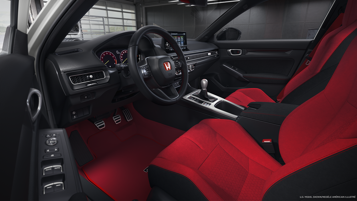 Wide shot of the cockpit, showcasing the red bucket sport seats and entire front dashboard.