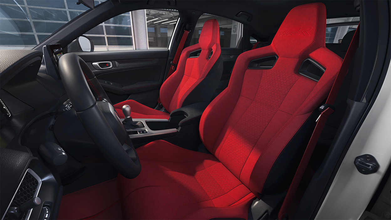 Wide shot of the two front red bucket sports seats.