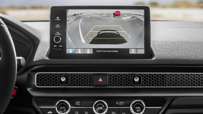 Closeup of touchscreen displaying a what the rear cross traffic monitor camera sees. 