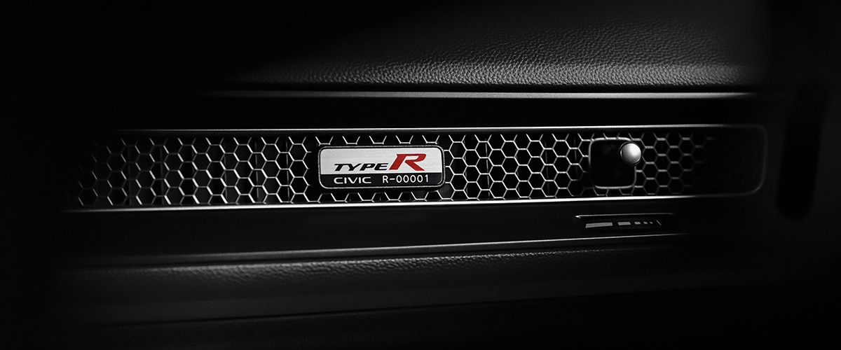 Closeup of Type R serial number plate on the honeycomb vent on the front passenger dashboard.