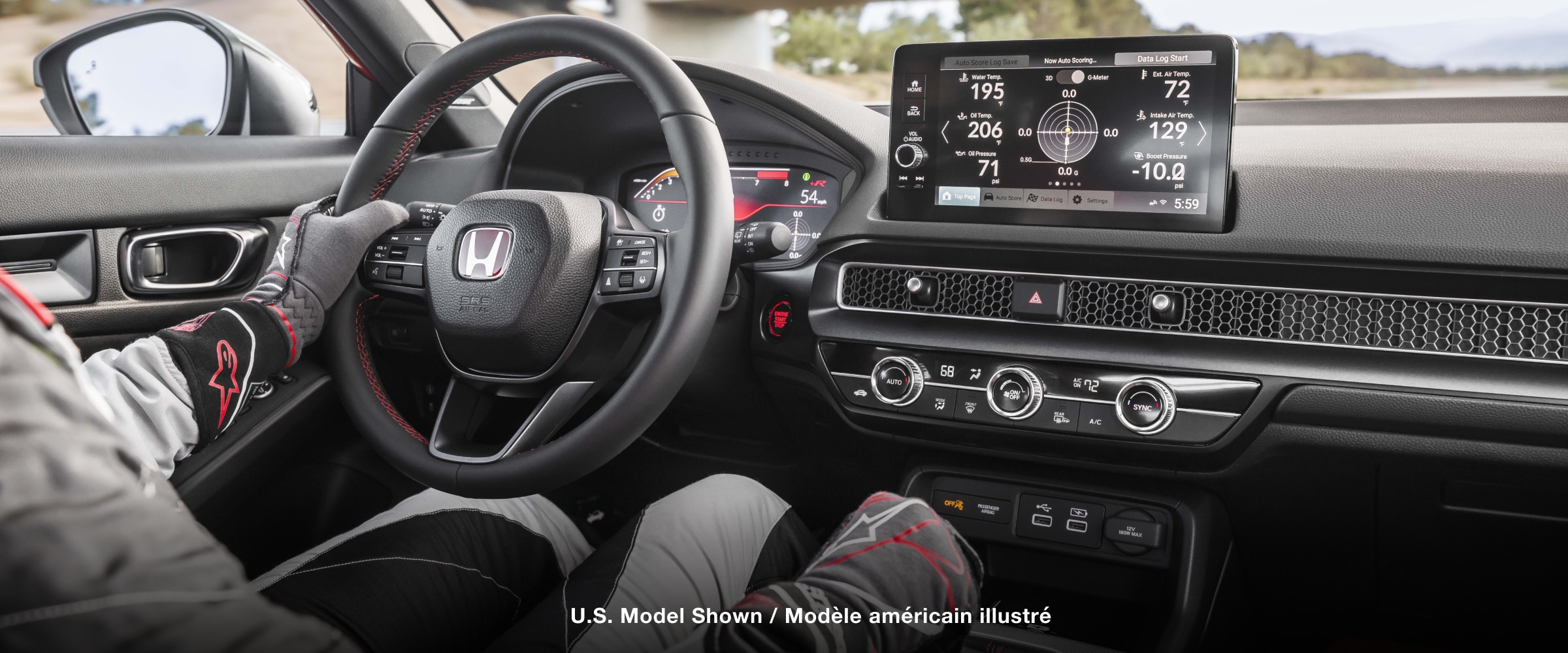 Interior view of race car driver holding wheel, showcasing the Type R interior and LogR™ info on the touchscreen display.
