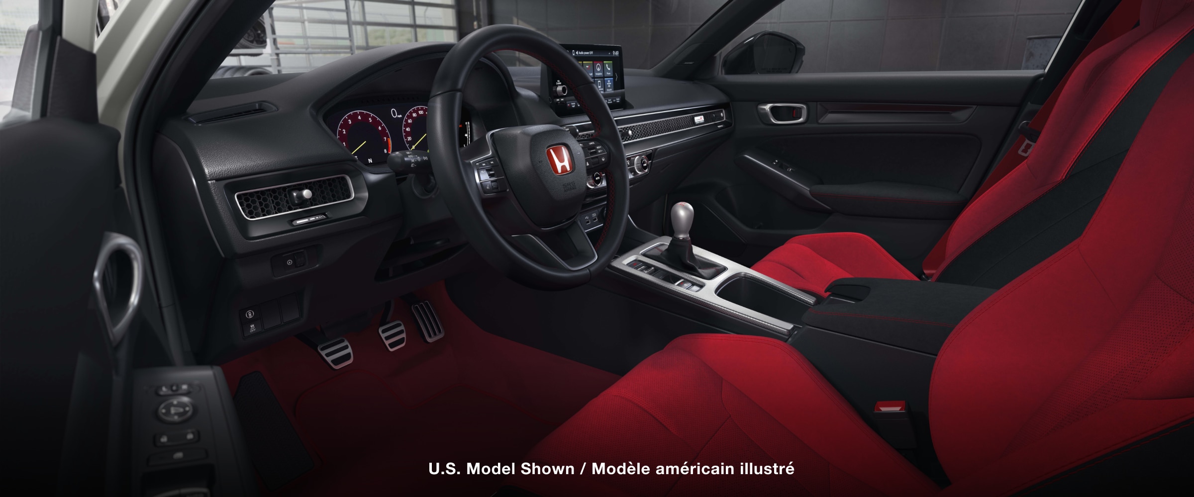 Wide shot of the cockpit, showcasing the red bucket sport seats and entire front dashboard.