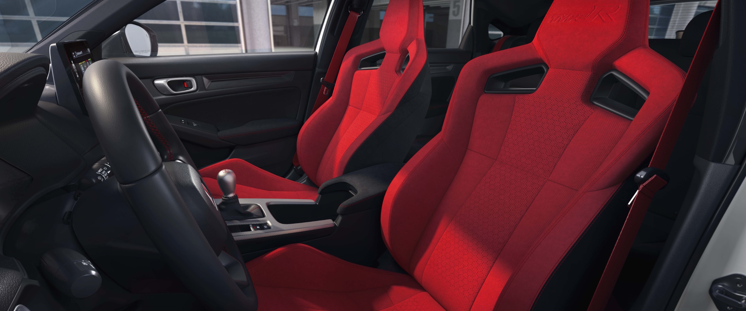 Wide shot of the two front red bucket sports seats.