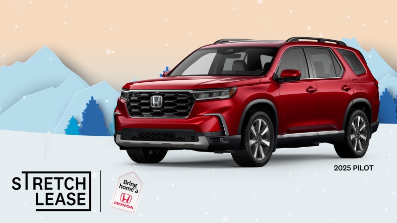 A red 2025 Pilot Touring with snowy mountains and trees in the background.