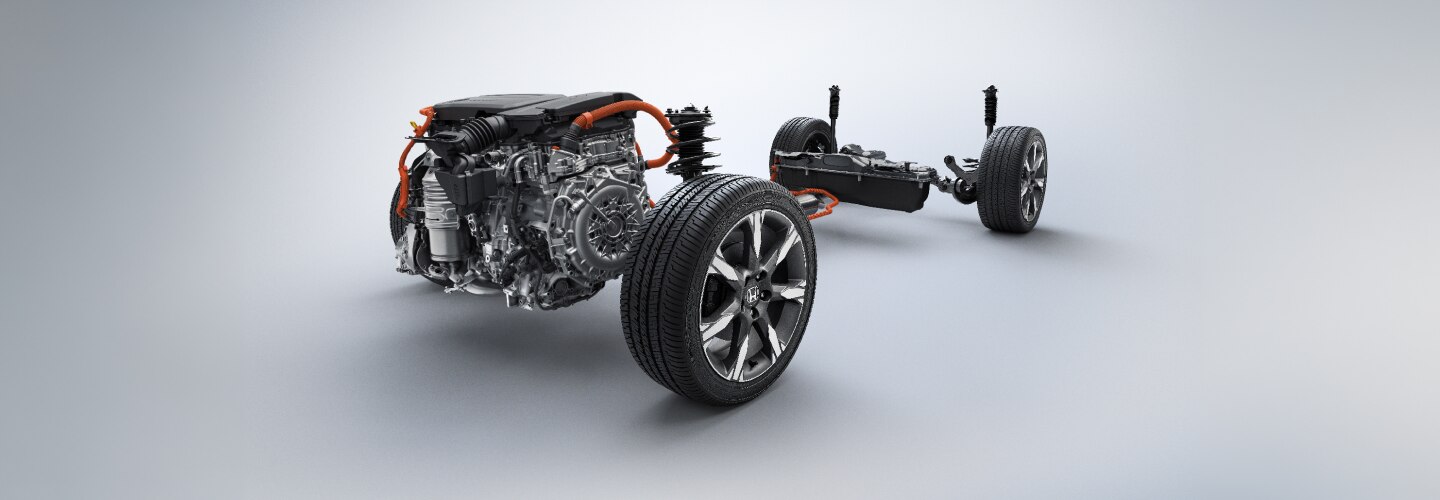 Le moteur et les roues d’un véhicule Honda illustrés sur un fond gris. 