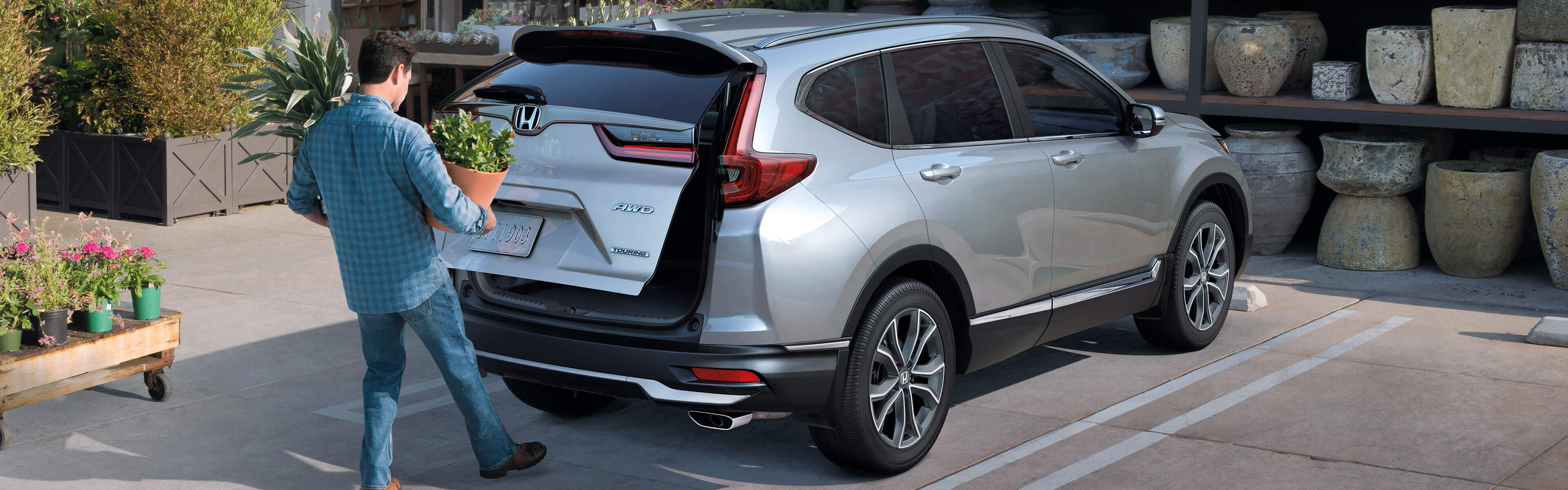 Rear passenger-side view of the 2021 Honda CR-V Touring demonstrating hands-free access power tailgate.
