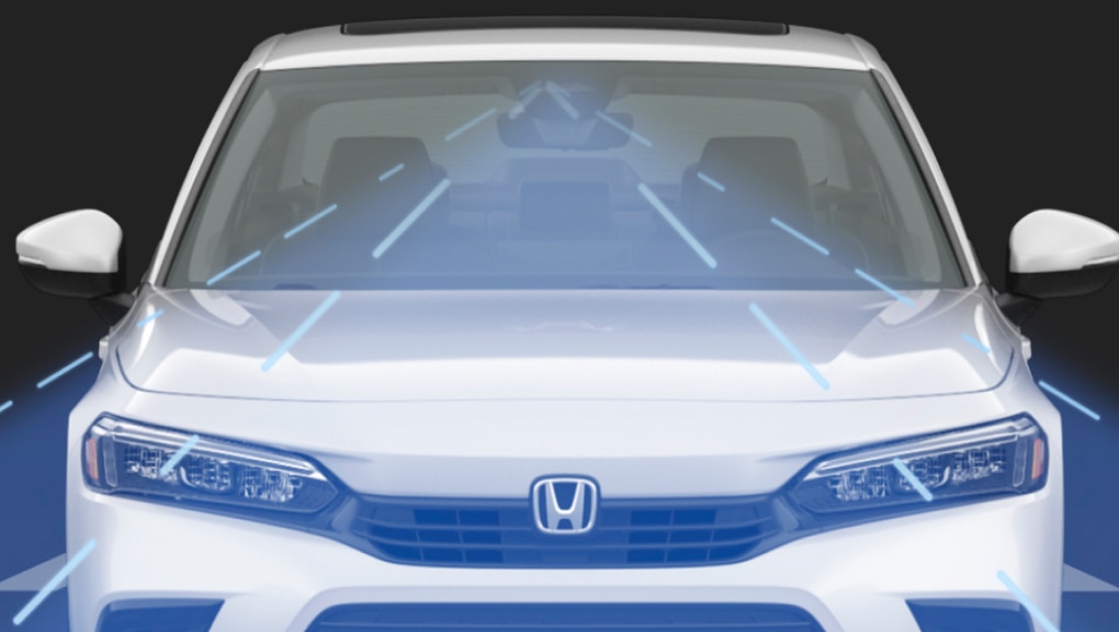 Forward-facing front end of a white 2022 Honda Civic in a black background with sensor technology depicted in the form of a wide beam cast out from the car’s new front camera.