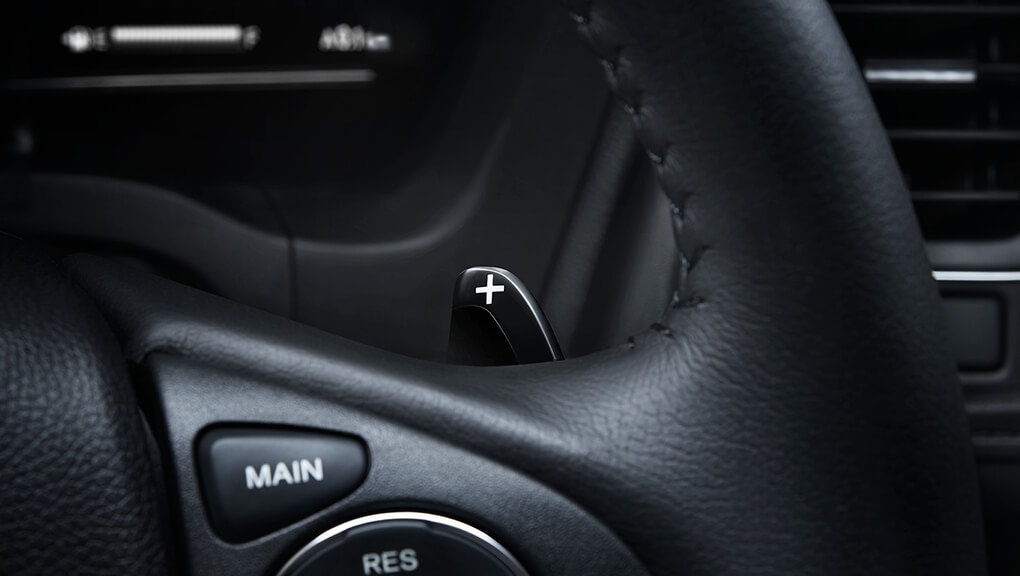 Detail view of a paddle shifter on the steering wheel in the 2022 Honda HR-V with Black Leather. 