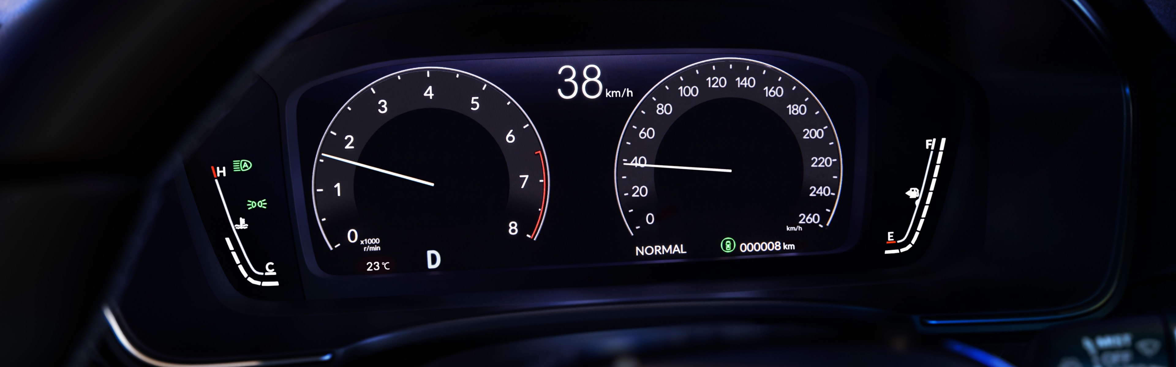 Close-up of Honda Civic Hatchback driver’s digital display through the top gap in the steering wheel.