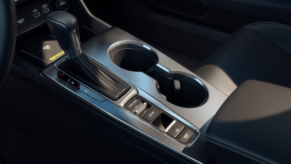 Close-up image of the centre console in a 2022 Honda Civic, including shifter, cup holders, arm rest and front tray.
