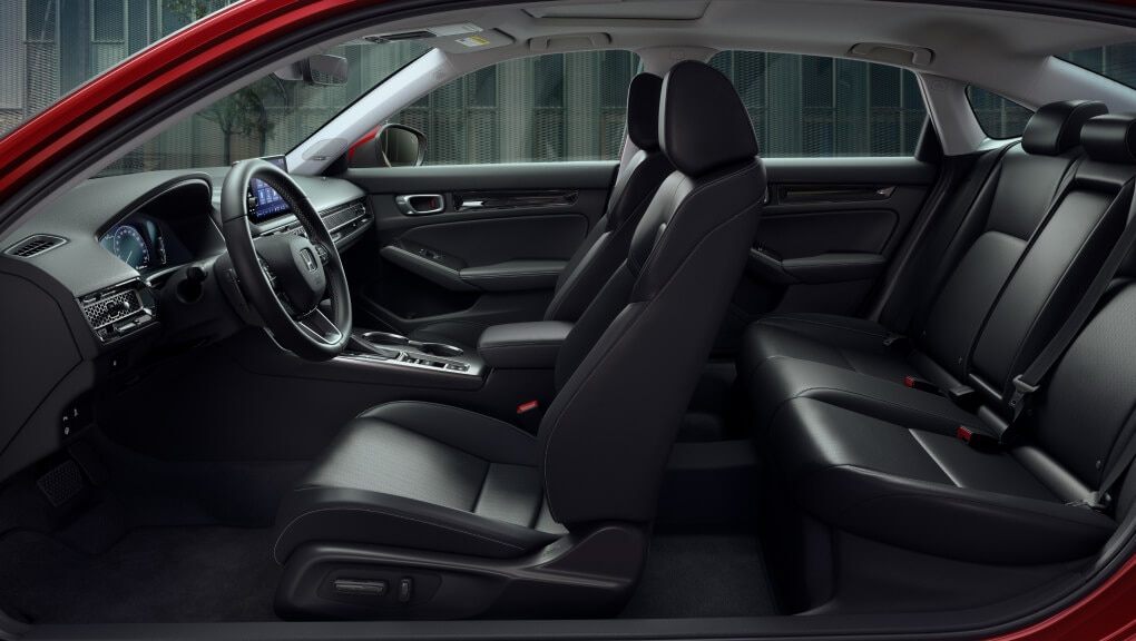 Full interior of a 2022 Honda Civic, shot with both doors removed for a complete view from the driver’s side showcasing a Bose® audio system with 12 speakers.