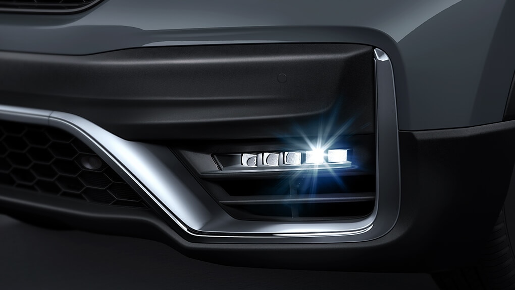 Driver-side fog light detail shot on the 2021 Honda CR-V Touring in Sonic Grey Pearl.