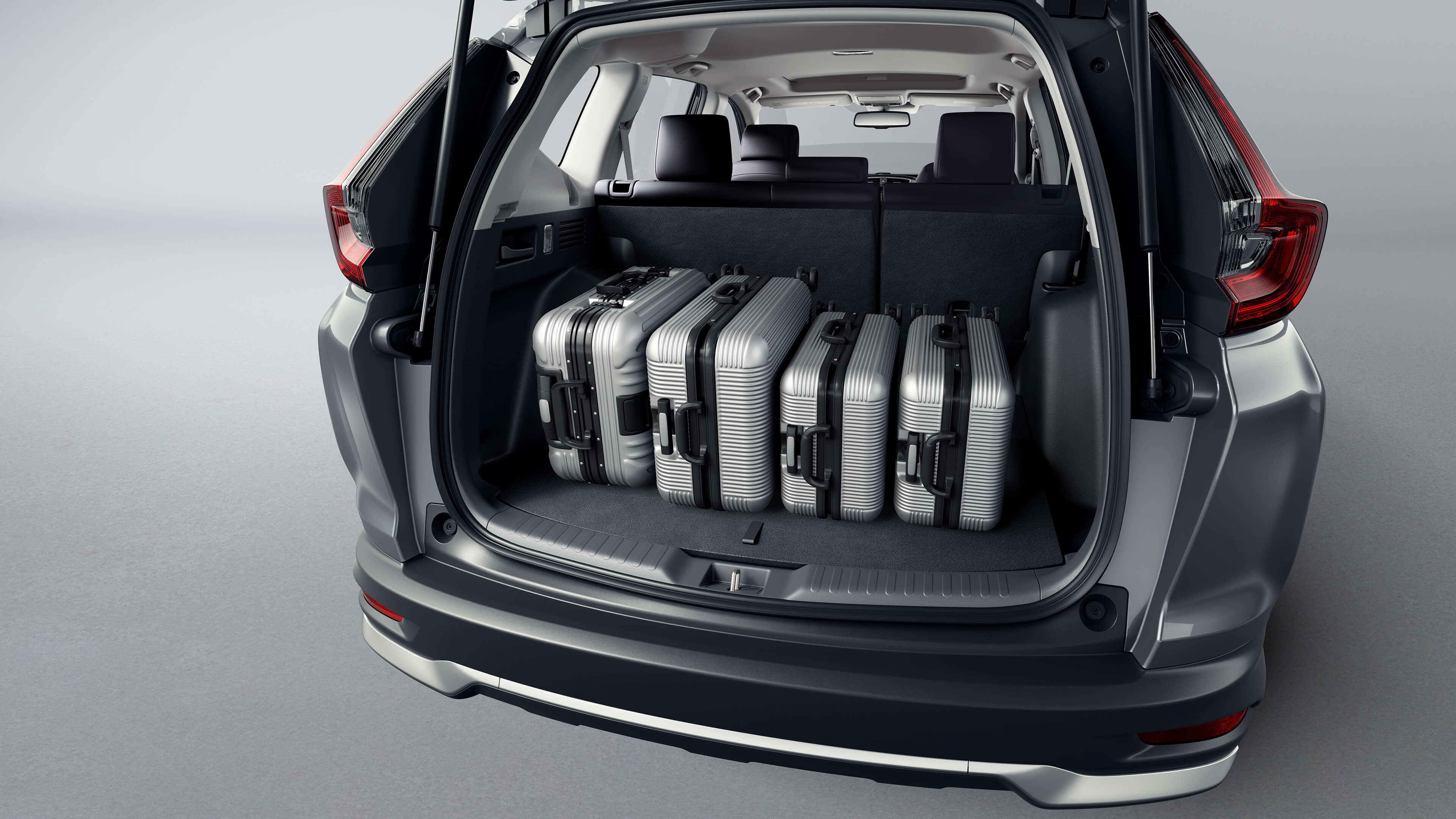 Interior cargo area view of the 2021 Honda CR-V Touring in Modern Steel Metallic, with gear loaded inside.