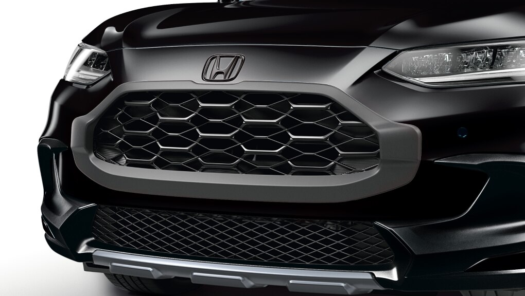 Closeup of all-black grille trim on the front of a black HR-V. 